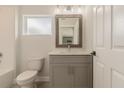 Modern bathroom with gray vanity, white toilet and shower/tub combo at 3623 Giblin Dr, North Port, FL 34286