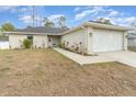 Newly built home with a two-car garage and landscaped front yard at 3623 Giblin Dr, North Port, FL 34286