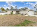 Single-story house with gray siding and a white garage door at 3623 Giblin Dr, North Port, FL 34286