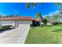 Front view of a house with a two-car garage and manicured lawn at 3803 Wilshire W Cir # 37, Sarasota, FL 34238