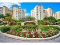 The Meridian building entrance with landscaped grounds at 385 N Point Rd # 402, Osprey, FL 34229