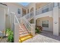 Clean condo building stairwell with light colored walls and railing at 4264 Central Sarasota Pkwy # 122, Sarasota, FL 34238