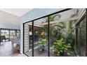 Private courtyard with lush tropical plants, accessible through sliding glass doors at 4372 Woodmans Chart # 143, Sarasota, FL 34235