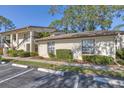 Condo building exterior showcasing parking and landscaping at 4717 Winslow Beacon # 7, Sarasota, FL 34235