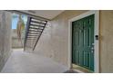 Exterior view of condo building showing walkway, stairs, and a dark green front door at 5180 Northridge Rd # 101, Sarasota, FL 34238