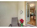 Inviting front entry with a chair, potted plant, and view into the home at 5552 Eagle Creek Rd, Sarasota, FL 34238