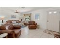 Living room with leather furniture and tile floors at 605 Jungle Queen Way, Longboat Key, FL 34228