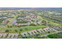 Aerial view showing community, golf course, and lake at 6085 Clubside Dr # 7682, Sarasota, FL 34243