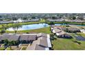 Aerial view showcasing community with lake and lush green spaces at 6131 Heritage Ln # 6131, Bradenton, FL 34209