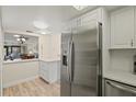 Kitchen boasts stainless steel fridge and white cabinetry at 6131 Heritage Ln # 6131, Bradenton, FL 34209