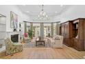 Spacious living room featuring hardwood floors and a cozy fireplace at 662 Fernwalk Ln, Osprey, FL 34229