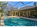 Inviting pool and spa area with screened enclosure and patio furniture at 662 Fernwalk Ln, Osprey, FL 34229