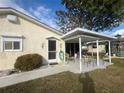 Covered patio with seating area and access to the backyard at 7564 Joppa St, North Port, FL 34287