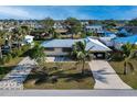 Single-story home with metal roof, driveway, and landscaping at 817 Linnaen Nw Ter, Port Charlotte, FL 33948