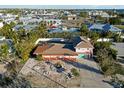 Aerial view of a light pink house with a large yard at 128 51St St # A, Holmes Beach, FL 34217