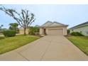 Single-story house with a two-car garage and well-manicured lawn at 1479 Blue Horizon Cir, Bradenton, FL 34208