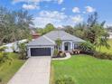 Single-story house with a large yard and driveway at 1604 21St W Ave, Palmetto, FL 34221