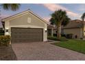 Front view of a single story home with a brown garage door at 19256 Jalisca St, Venice, FL 34293