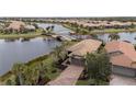 Home's exterior with a canal and bridge view in a residential community at 19261 Isadora St, Venice, FL 34293