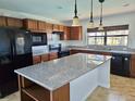 Modern kitchen with granite countertops and island at 19261 Isadora St, Venice, FL 34293