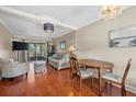 Living room with hardwood floors, wicker furniture, and sliding glass door at 2047 Canal Dr # L6, Bradenton, FL 34207