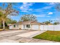 Tan house with white garage door and landscaping at 2341 Spring Oaks Cir, Sarasota, FL 34234