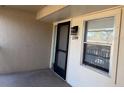 Condo building entryway with screen door and window at 2599 Woodgate Ln # K7, Sarasota, FL 34231