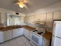 Condo kitchen with white cabinets and appliances at 2599 Woodgate Ln # K7, Sarasota, FL 34231