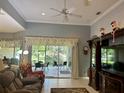 Living room with sliding glass doors opening to a patio and backyard view at 3312 92Nd E Ave, Parrish, FL 34219