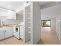 Modern white kitchen with new appliances and light wood tile flooring at 4001 Beneva Rd # 208, Sarasota, FL 34233