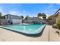 Community pool with lounge chairs at 4001 Beneva Rd # 208, Sarasota, FL 34233