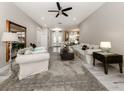 Spacious living room with light beige walls, tiled floor, and comfy sofas at 4539 Longspur Ln, Sarasota, FL 34238