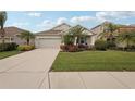 Single-story home with a two-car garage and well-maintained lawn at 4629 Garden Arbor Way, Bradenton, FL 34203