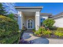 Inviting entryway with lush landscaping and a paved walkway at 4838 88Th E St, Bradenton, FL 34211