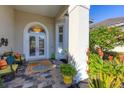 Relaxing front porch with seating area, colorful plants, and a decorative rug at 4838 88Th E St, Bradenton, FL 34211