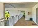 White hallway with tiled floor and balcony access, offering natural light at 5055 Gulf Of Mexico Dr # 424, Longboat Key, FL 34228