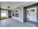 Inviting front porch with white door and neutral color palette at 5117 19Th E Ln, Bradenton, FL 34203