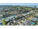 Aerial view of waterfront home community showcasing a luxurious house with a pool at 550 Yardarm Ln, Longboat Key, FL 34228