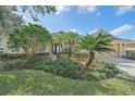 House exterior featuring lush landscaping and a two-car garage at 5655 Eastwind Dr, Sarasota, FL 34233