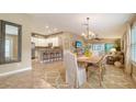 Bright dining room featuring a large wooden table and kitchen views at 5890 Guarino Dr, Sarasota, FL 34238