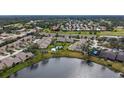 Aerial view showcasing a villa community near a lake at 5911 Doral Dr, Sarasota, FL 34243