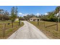 Long gravel driveway with gated entrance at 6424 18Th E Ave, Bradenton, FL 34208