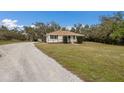 Gravel driveway leading to a charming ranch house at 6424 18Th E Ave, Bradenton, FL 34208