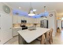 Modern kitchen with stainless steel appliances and an island at 6579 Willowshire Way, Bradenton, FL 34212