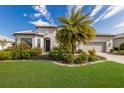 Single-Gathering home with palm tree and manicured landscaping at 712 Sigsbee Loop, Sarasota, FL 34240