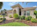 Well-maintained house with a lush lawn and a paved driveway at 7312 Riviera Cv, Lakewood Ranch, FL 34202