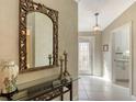 Elegant entryway with a large mirror and glass-top console table at 7575 Quinto Dr, Sarasota, FL 34238