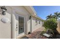 Front door entry with brick walkway and landscaping at 7575 Quinto Dr, Sarasota, FL 34238