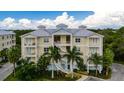 Three-story building with balconies, palm trees, and parking at 7910 34Th W Ave # 102, Bradenton, FL 34209