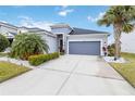 Single-story house with gray siding, palm trees, and driveway at 10531 Piedra Dr, Palmetto, FL 34221